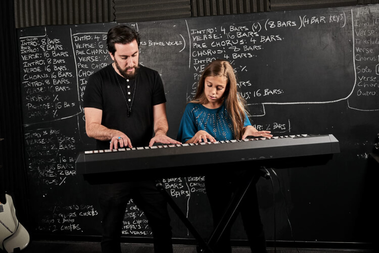 Instructor and student taking advanced keyboard and piano lessons