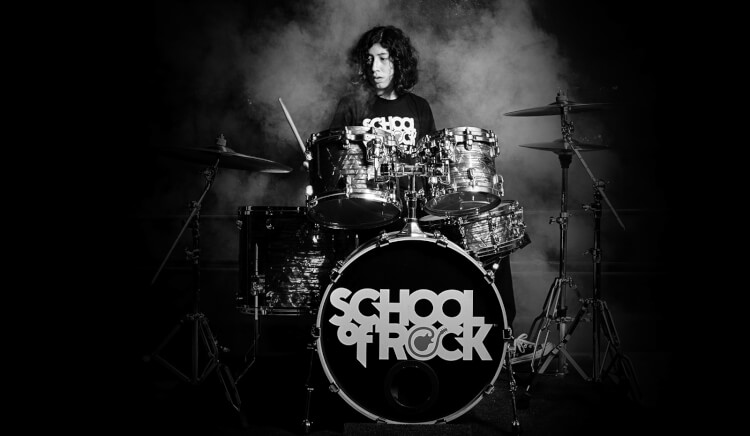 youth taking drum lessons at school of rock