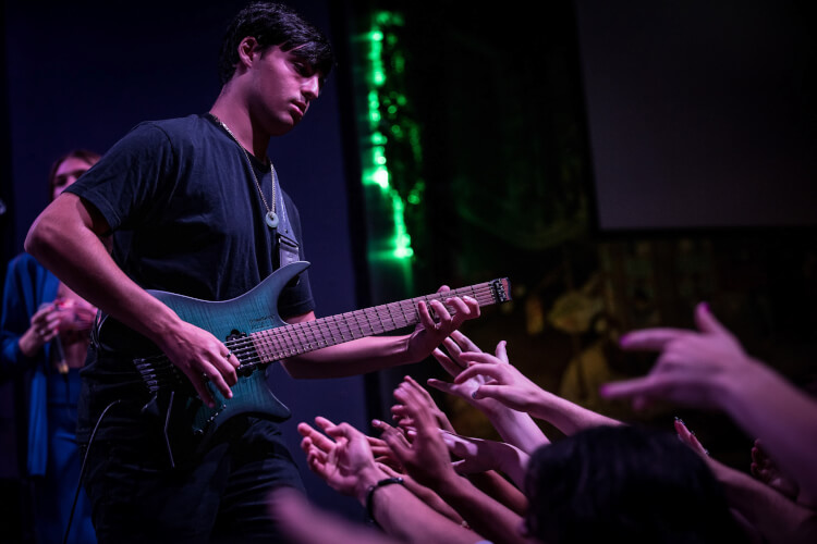 School of Rock guitar student performing on stage