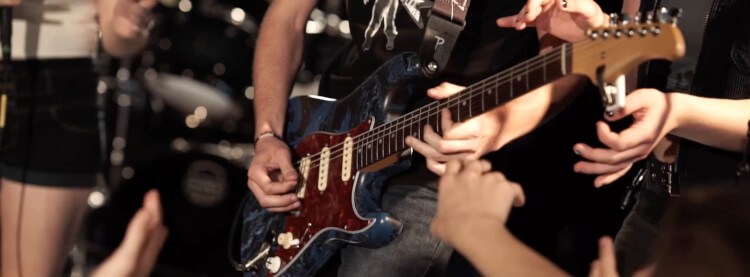 Teen playing guitar in School of Rock's Performance Program